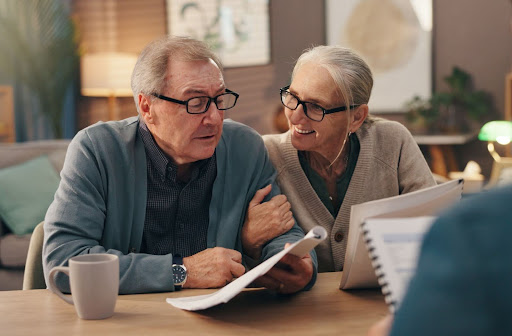 A senior couple smile as they decide to move into an independent living community