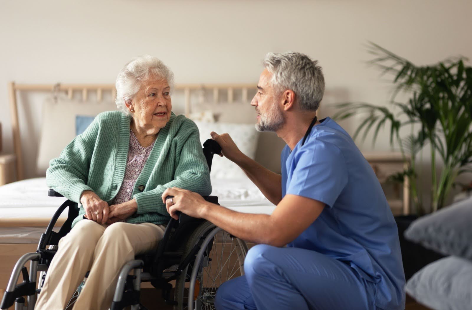 A caregiver comforts a senior resident in a senior living community.